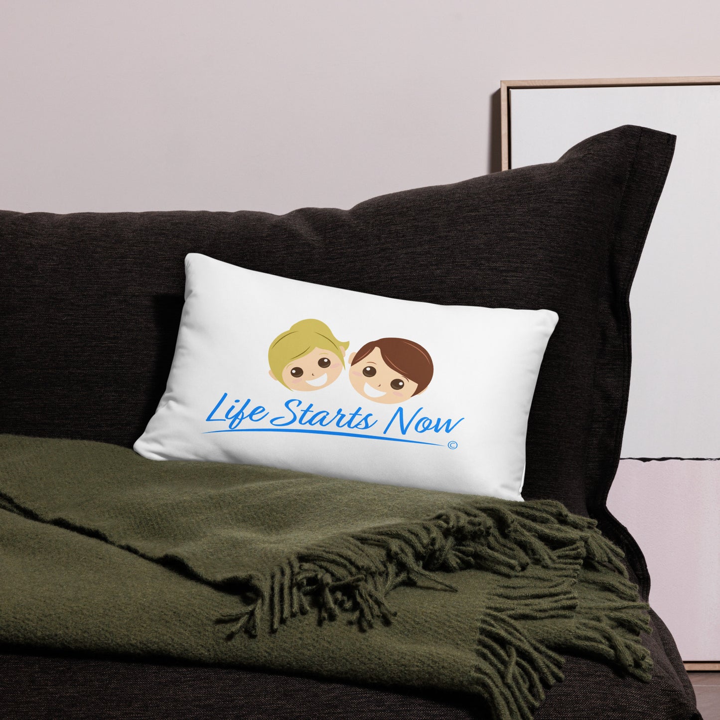 Cozy pillow adorned with the encouraging phrase 'Life Starts Now,' enhancing the aesthetic of a black bed and a green blanket
