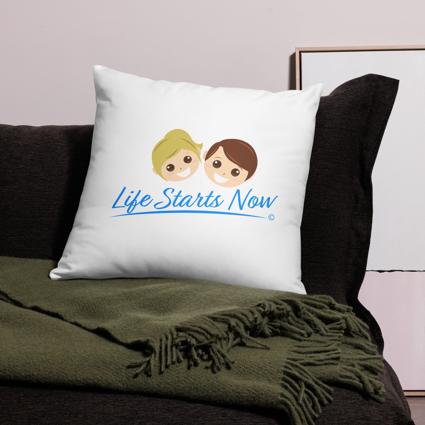 stylish 22x22 throw pillow on a black bed, displaying the uplifting message 'Life Starts Now. There's a green blanket beside it