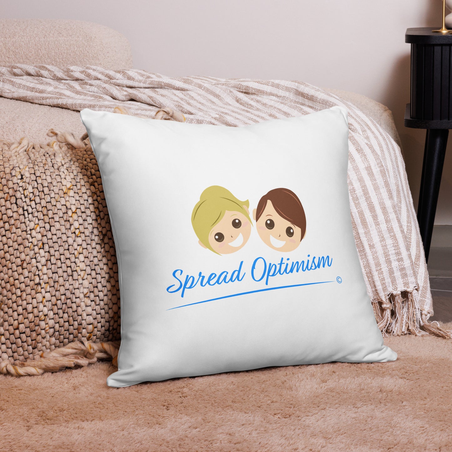 Charming 22x22 throw pillow inspiring optimism with 'Spread Optimism,' positioned beautifully on a pink carpet and a fashionable pink checkered scarf.
