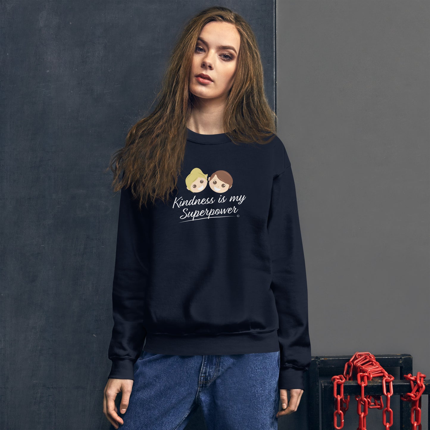 A stylish woman confidently modeling a cozy unisex sweatshirt in navy, both adorned with the empowering quote 'Kindness is my Superpower' in bold lettering.
