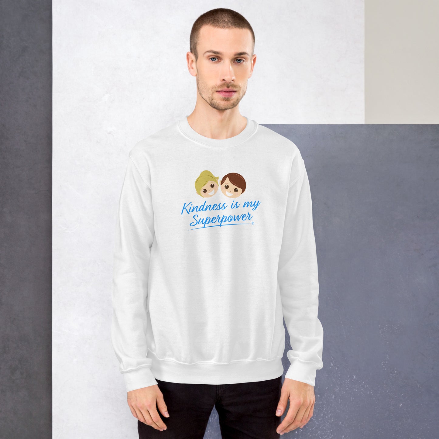 A stylish man confidently modeling a cozy unisex sweatshirt in white, adorned with the empowering quote 'Kindness is my Superpower' in bold lettering.