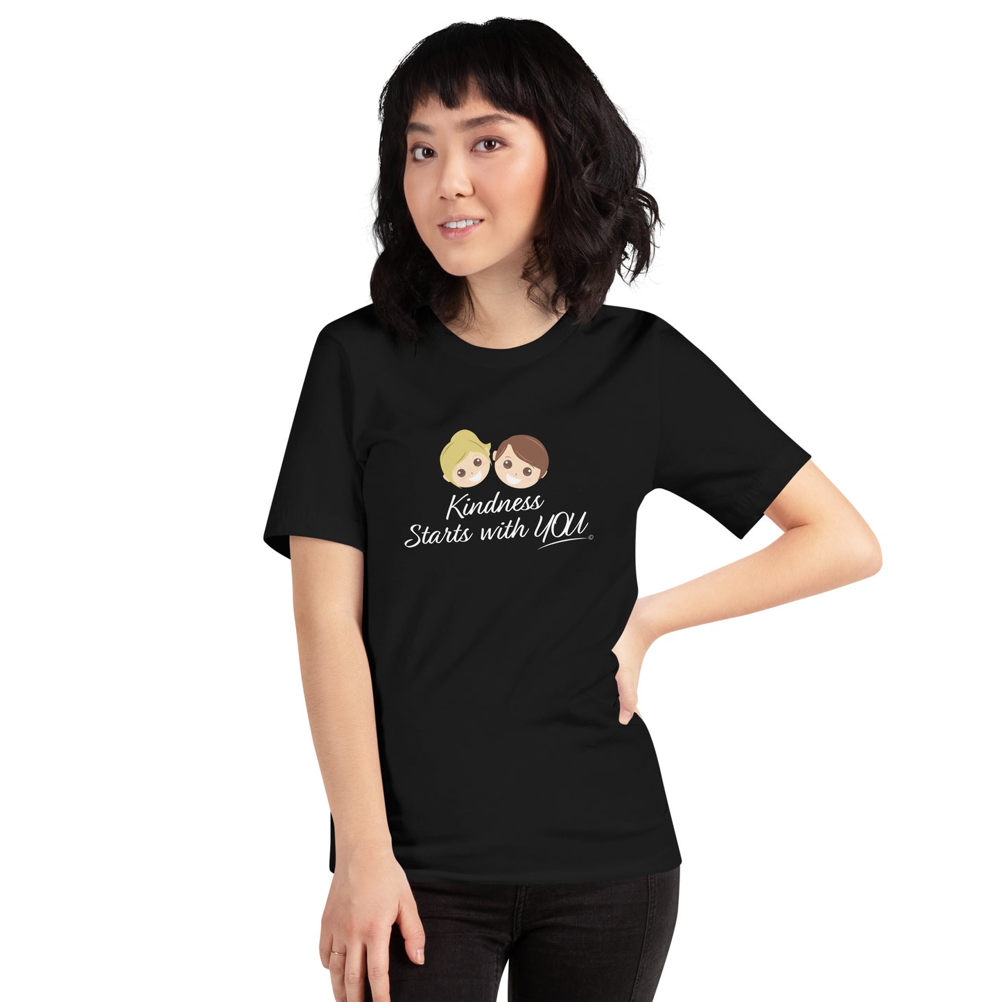 A smiling woman proudly modeling a versatile black unisex t-shirt with the inspiring quote 'Kindness Starts with You' in bold lettering.