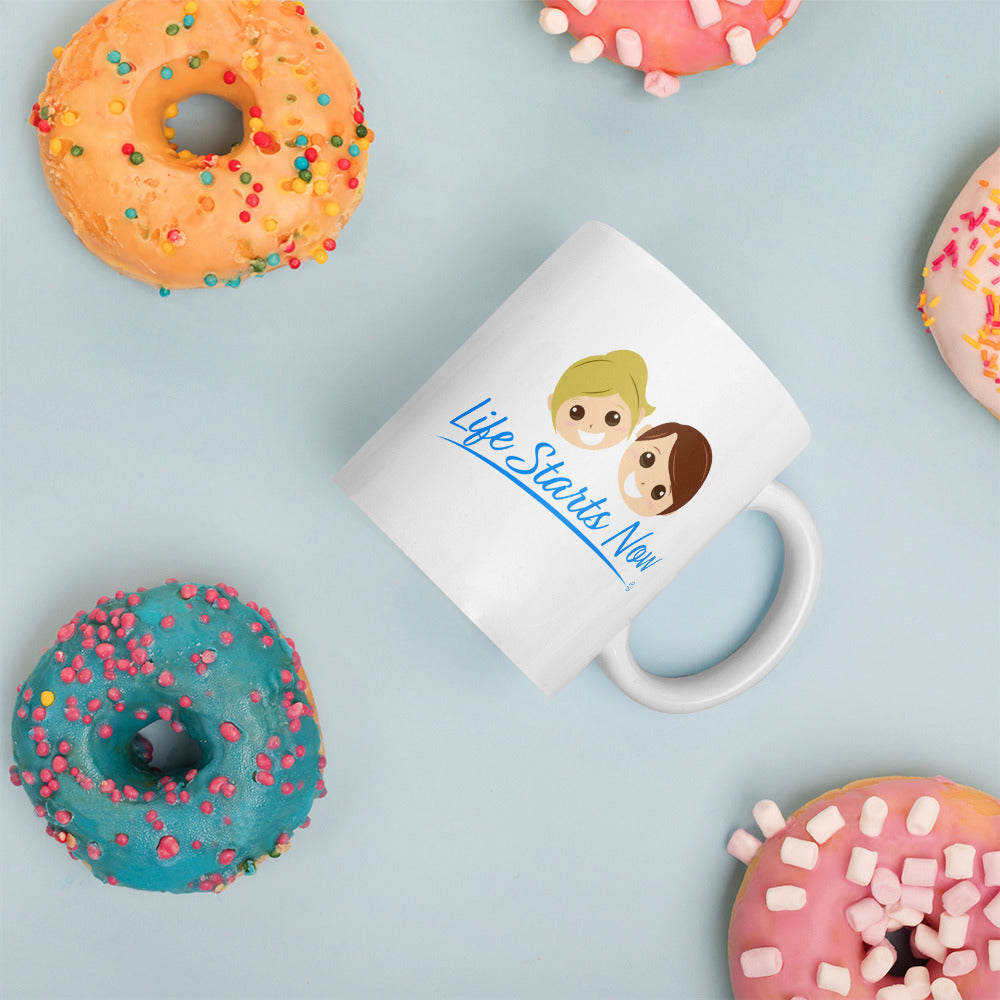 Glossy white latte mug with donuts in the background