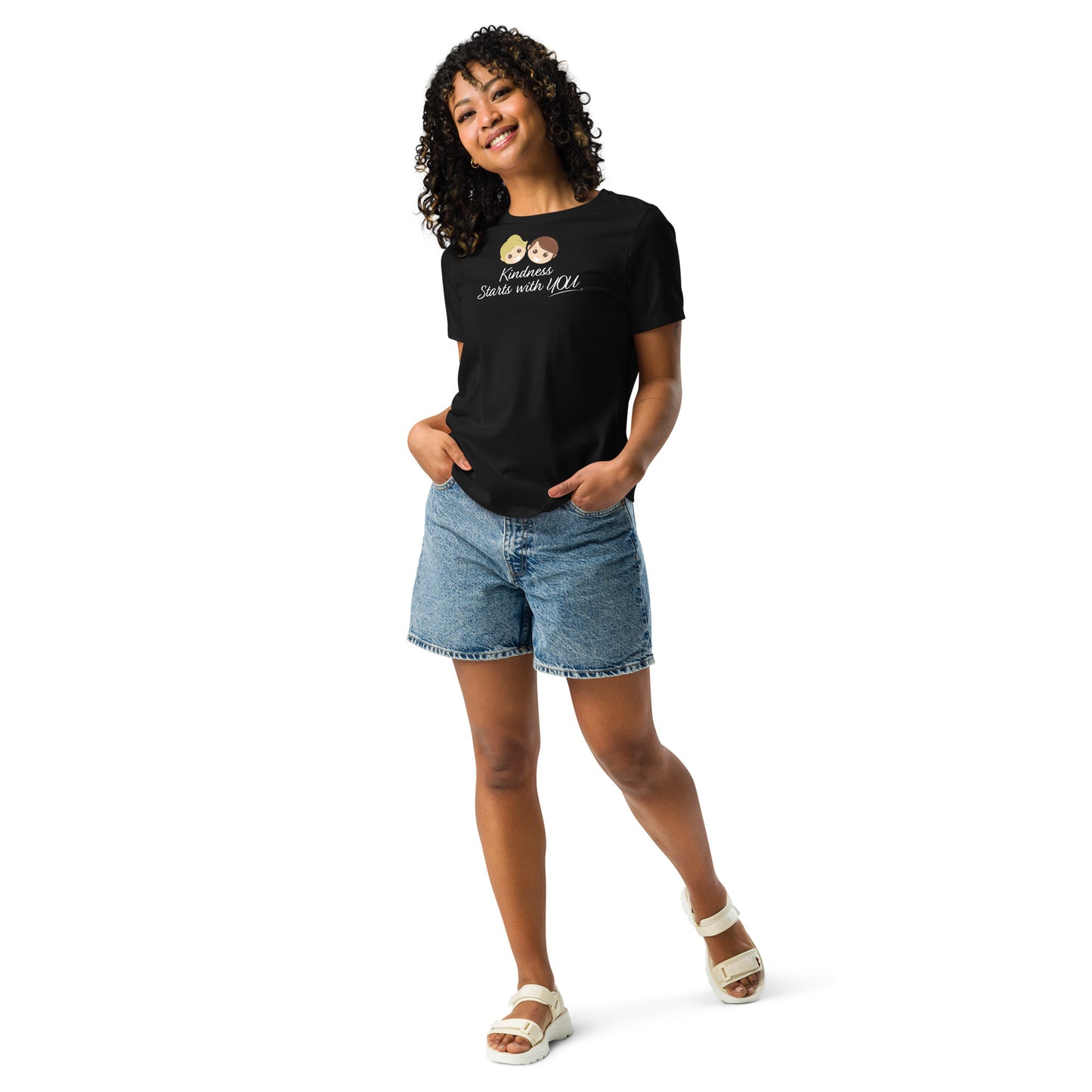 A smiling woman showcasing a stylish women's shirt in black, featuring the empowering quote 'Kindness Starts with You' in bold lettering.