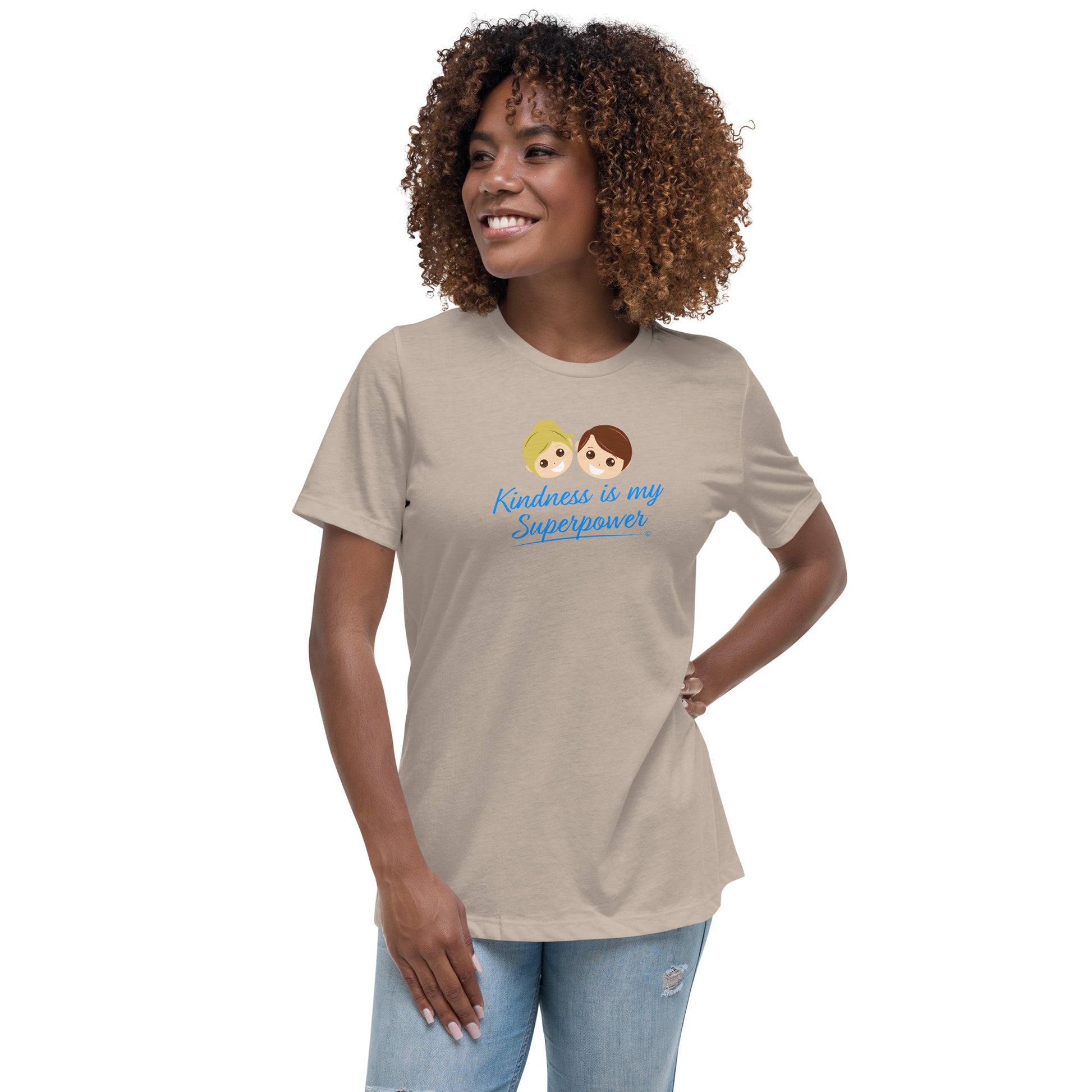A smiling young woman wearing a heather stone shirt with the empowering quote 'Kindness is my Superpower' in bold lettering.